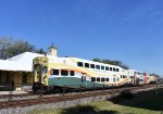 The Sunrail train passes the Amtrak Station building